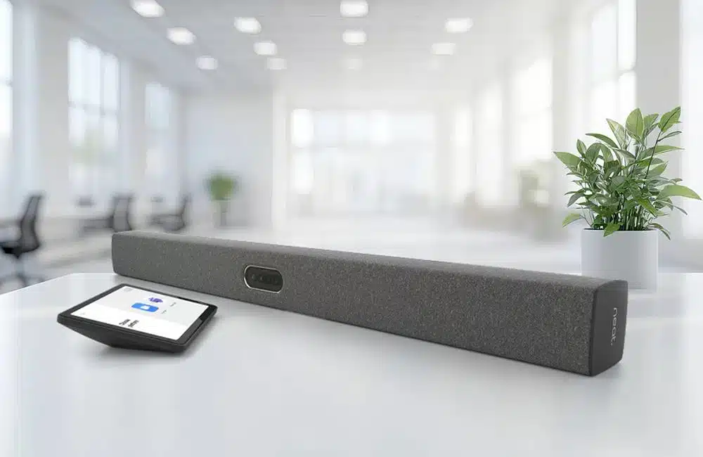 Soundbar and touchscreen on a white table in a bright office